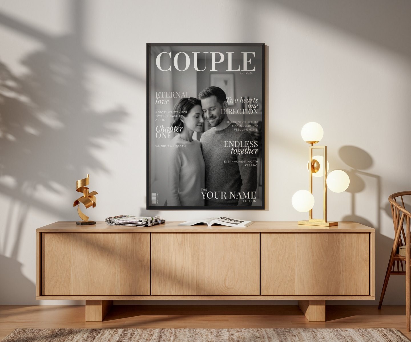 Couple Edition in a black frame above an oak sideboard